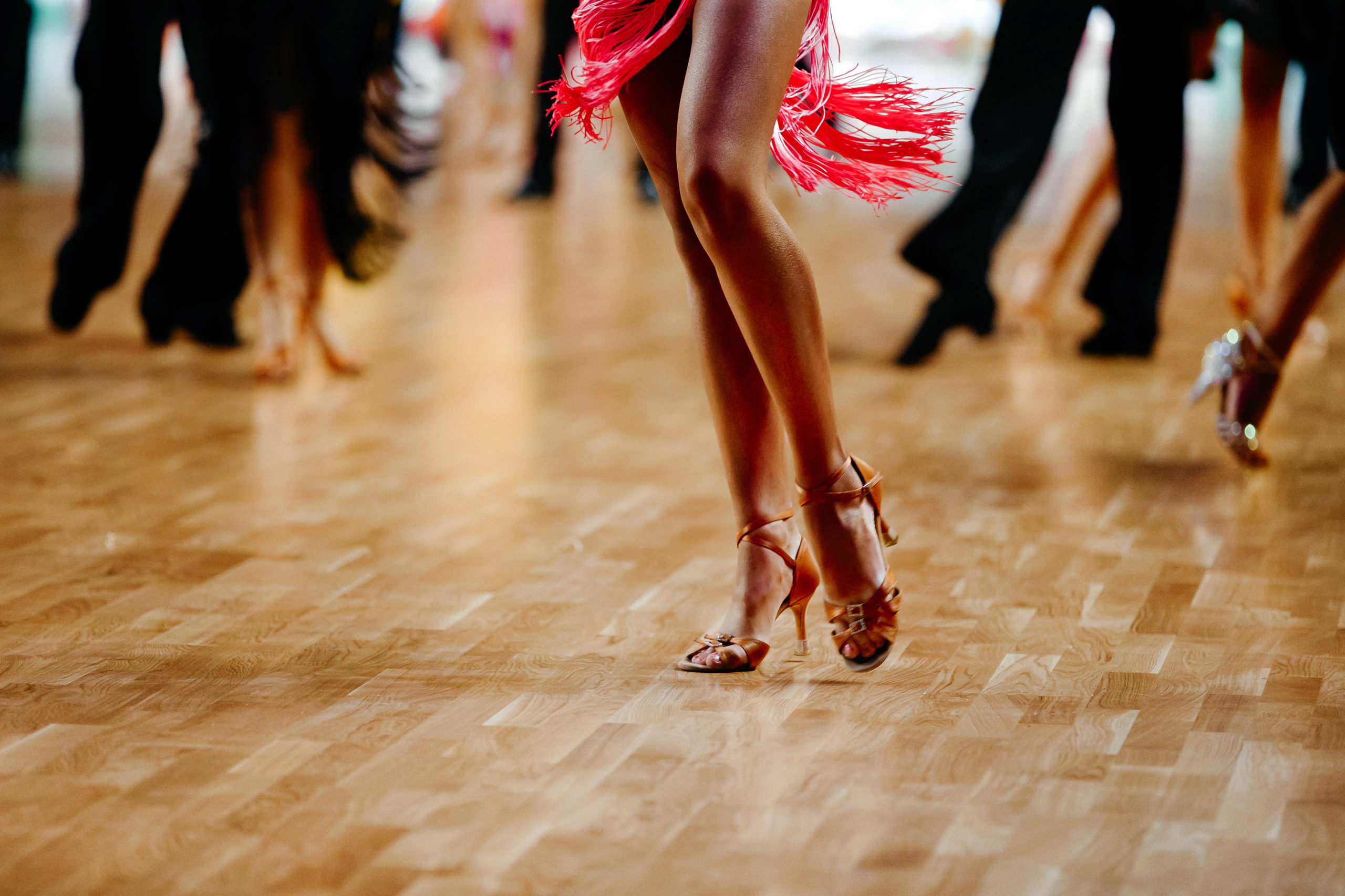 Female Latin dancer dancing alone on crowded floor