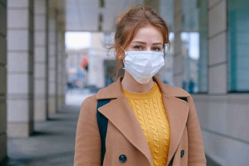 Woman wearing face mask on way to a dance class