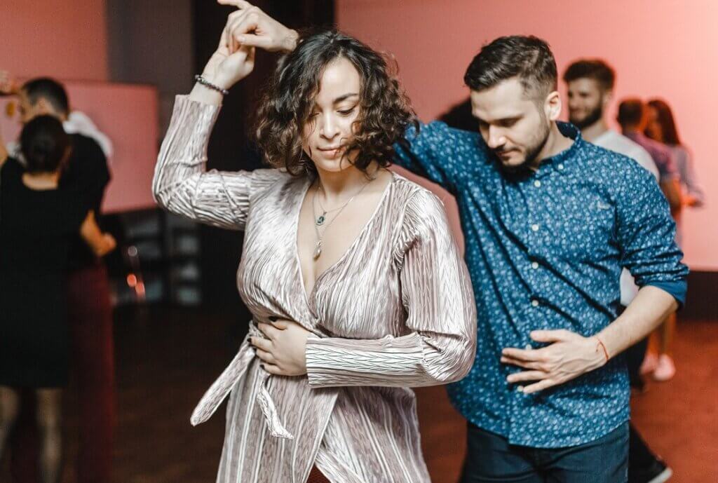 Couple dance salsa romántica at a party